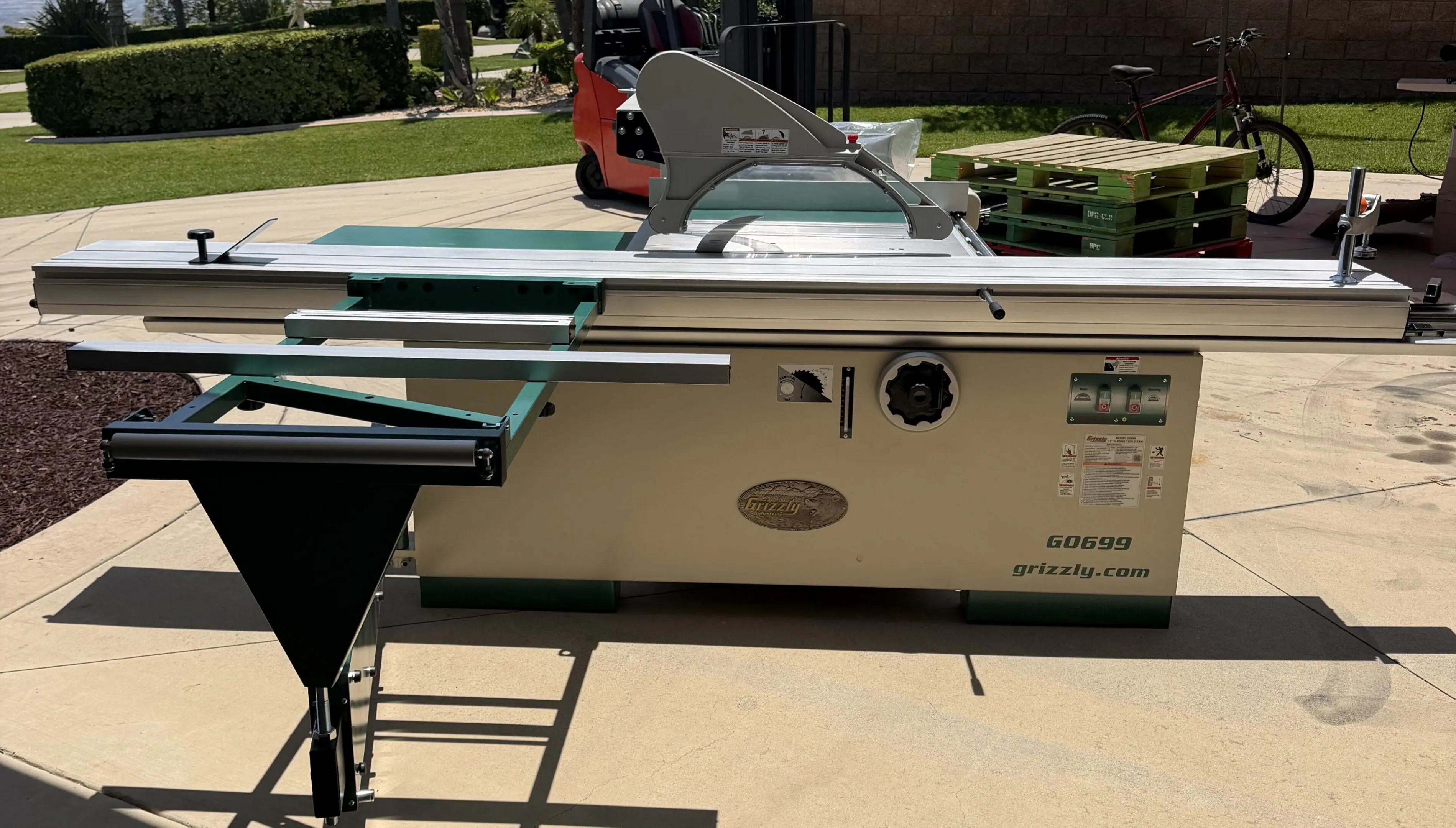 Sliding table saw with outfeed support outdoors