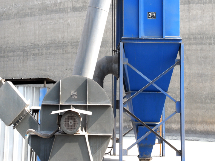 Large industrial machine against concrete wall.