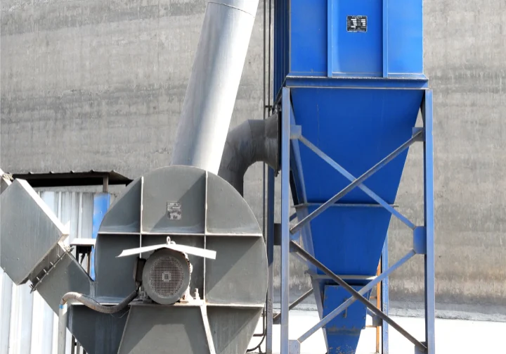 Large industrial machine against concrete wall.